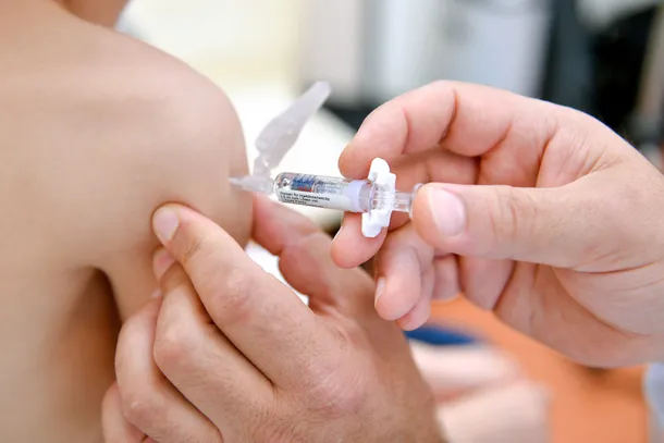 Una enfermera aplicando una vacuna a un niño
