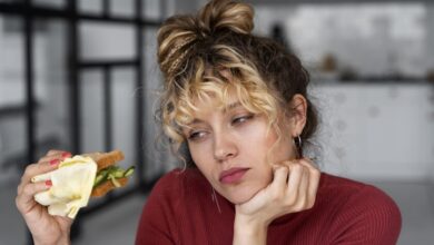 Una persona con cara de enfado y un plato de comida vacío