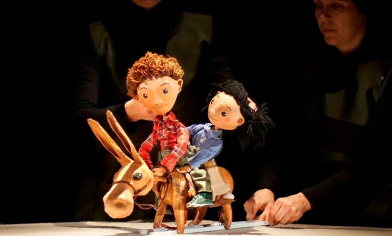 Imagen de una función de teatro al aire libre con público diverso