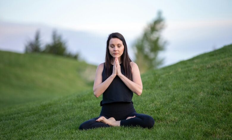 Persona practicando meditación con los ojos cerrados y las manos en posición de relajación