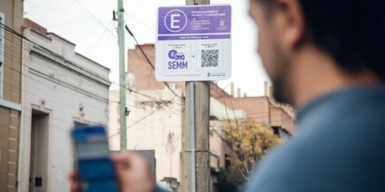 Imagen de un coche estacionado en la calle con un código QR en el parabrisas