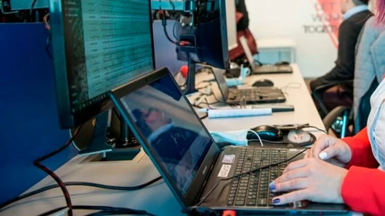 Imagen de una persona trabajando en una oficina, con un fondo de edificios de Córdoba