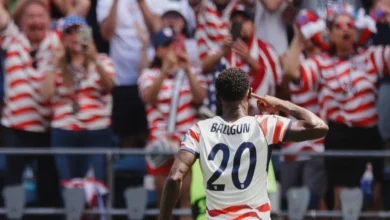 El árbitro del partido entre Estados Unidos y Australia es asistido por los jugadores después de sufrir una contractura