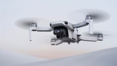 DJI Mini 4K en vuelo con un paisaje urbano al fondo