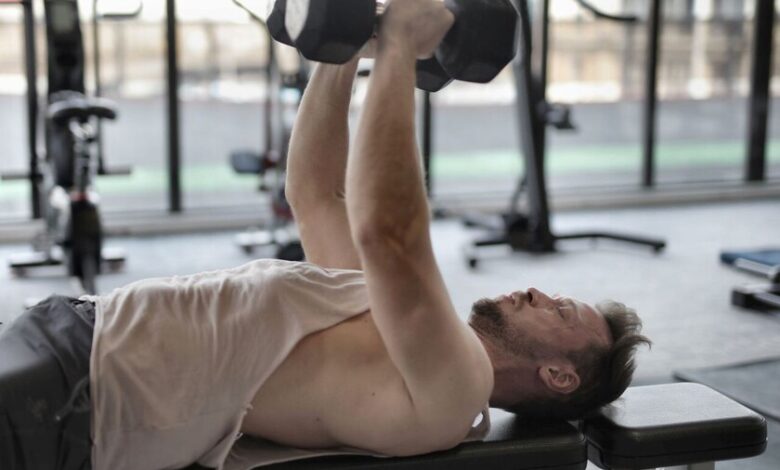 Persona mayor realizando ejercicios de fuerza en un gimnasio