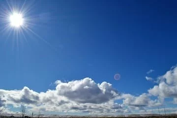 Vista del cielo de Córdoba al atardecer con nubes y sol